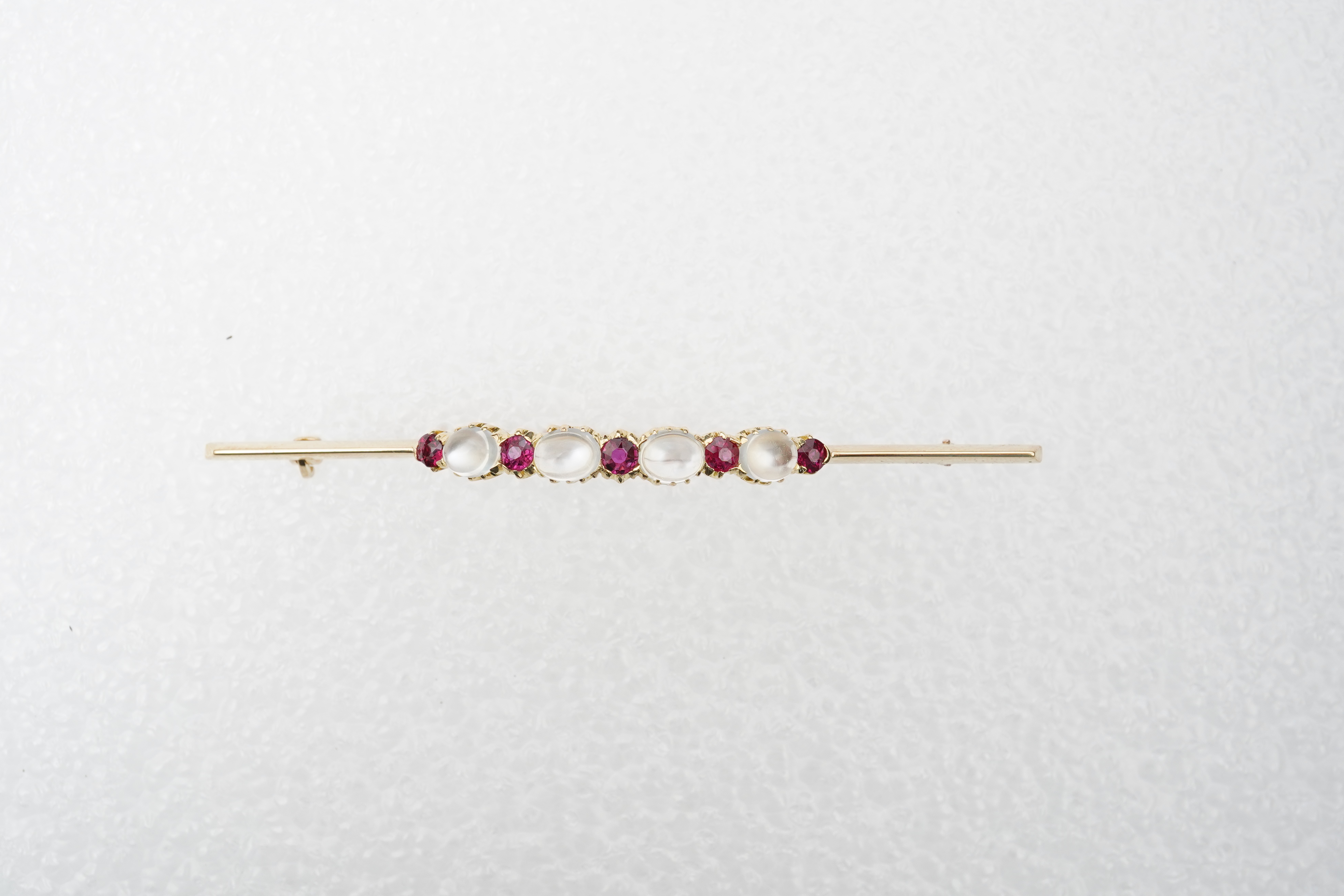 A moonstone and ruby brooch, circa 1900